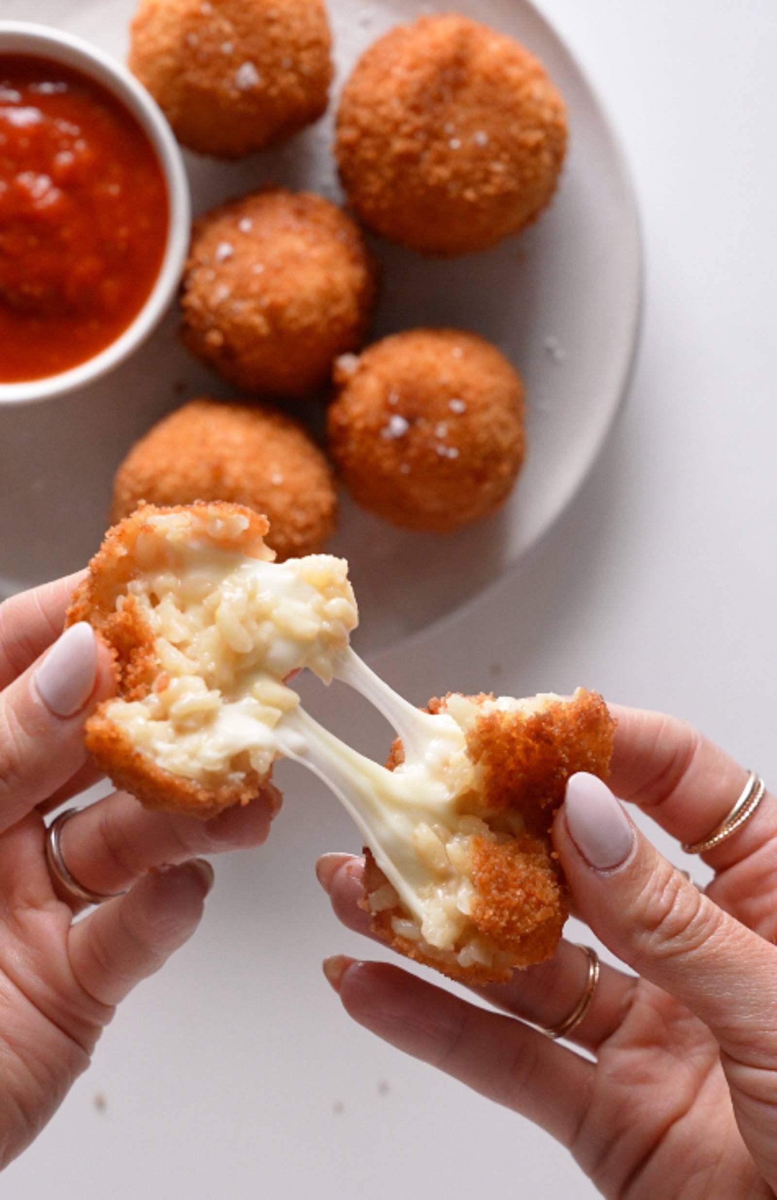 Pulling apart fried arancini.